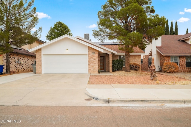 ranch-style house with central AC, a garage, and solar panels