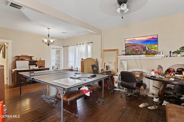 game room with a textured ceiling, dark hardwood / wood-style flooring, and ceiling fan with notable chandelier