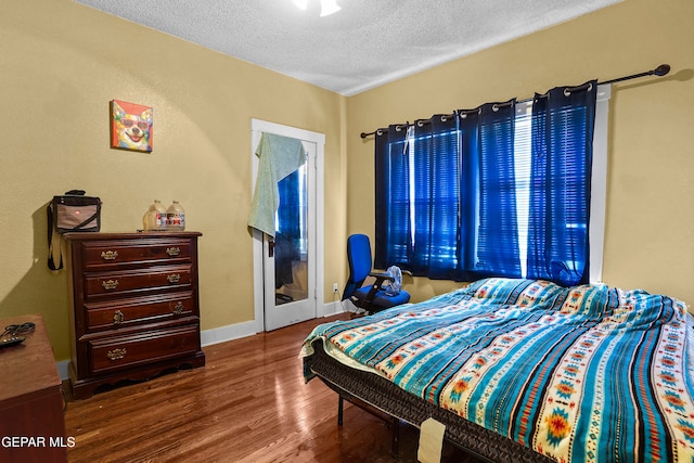 bedroom featuring hardwood / wood-style floors and a textured ceiling