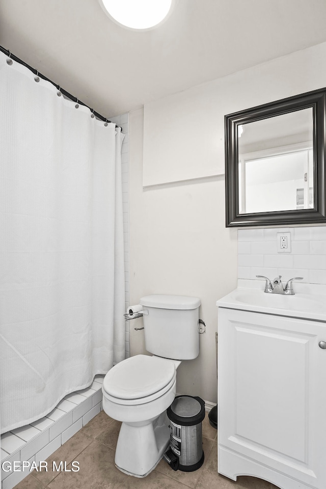 bathroom featuring vanity, toilet, curtained shower, and tile patterned flooring