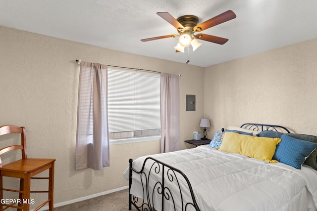 bedroom with electric panel, carpet floors, and ceiling fan