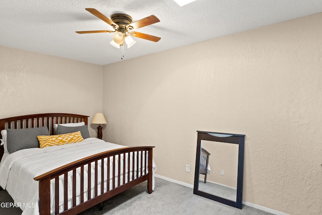 bedroom with light carpet, a textured ceiling, and ceiling fan