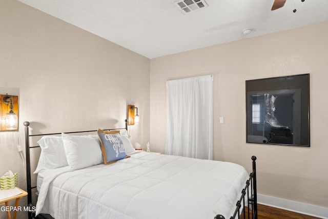 bedroom featuring dark hardwood / wood-style floors and ceiling fan