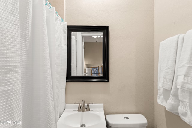 bathroom featuring sink and toilet