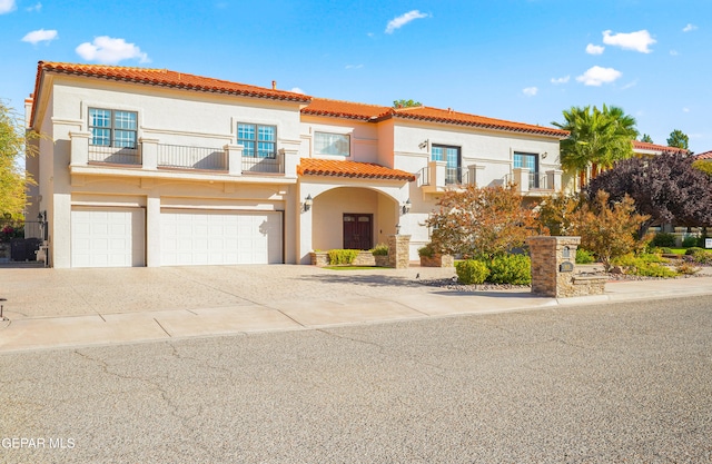 mediterranean / spanish-style house featuring a balcony and a garage