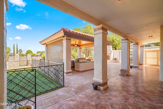 view of patio featuring an outdoor kitchen and ceiling fan