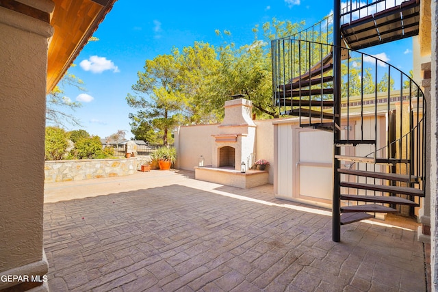 view of patio featuring an outdoor fireplace