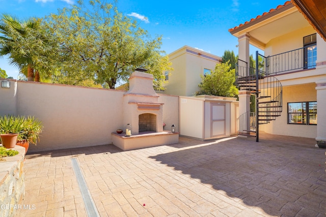 view of patio / terrace featuring an outdoor fireplace