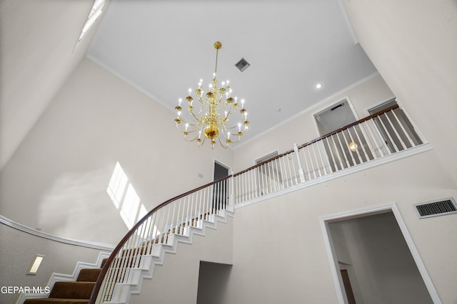 staircase with high vaulted ceiling, a notable chandelier, and crown molding