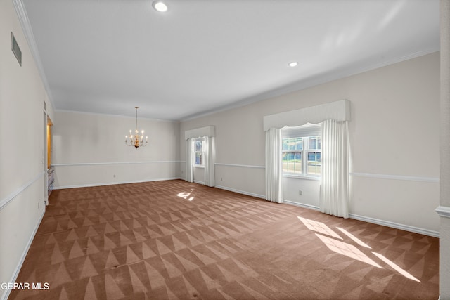 carpeted empty room featuring a notable chandelier and ornamental molding