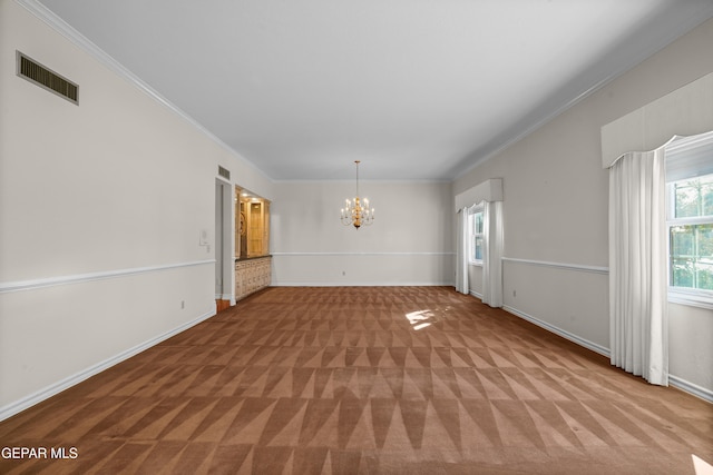 carpeted empty room with a chandelier and crown molding