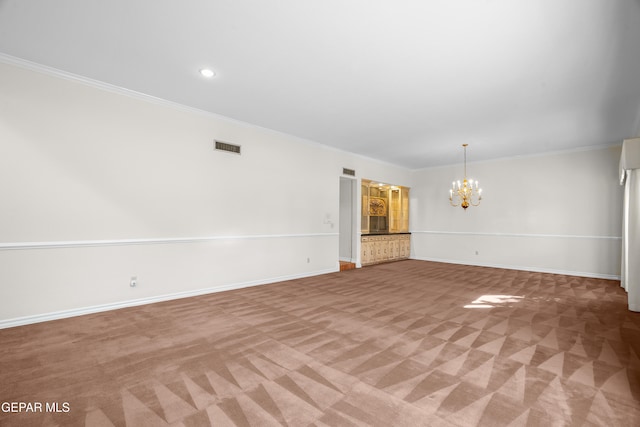 unfurnished living room with ornamental molding, light carpet, and a notable chandelier