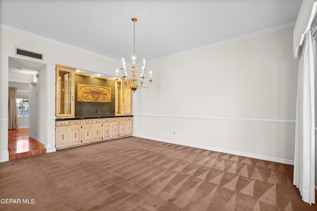 interior space with a notable chandelier, carpet flooring, and crown molding