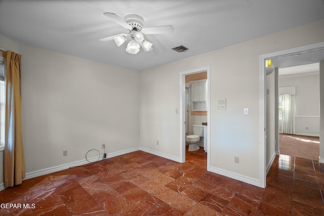 unfurnished bedroom with connected bathroom, a walk in closet, and ceiling fan