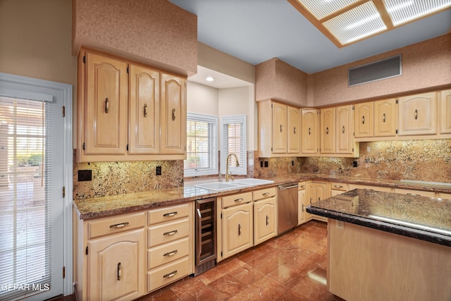 kitchen with sink, light stone countertops, backsplash, stainless steel dishwasher, and beverage cooler