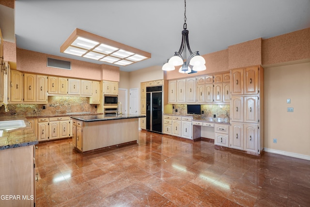 kitchen featuring built in appliances, sink, decorative light fixtures, a notable chandelier, and a center island