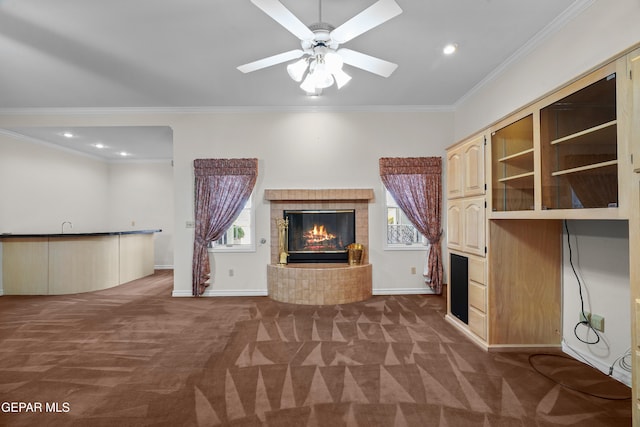 unfurnished living room featuring carpet floors, crown molding, and a tile fireplace