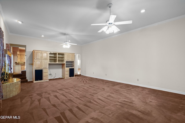 unfurnished living room with ornamental molding, ceiling fan, and dark carpet