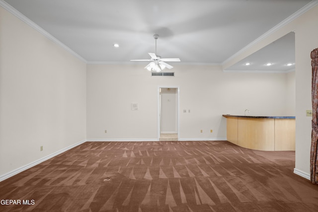 unfurnished living room featuring ornamental molding and dark carpet