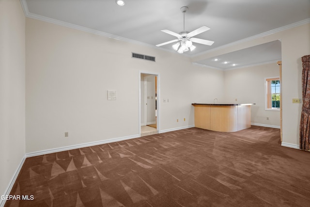 unfurnished living room with dark colored carpet, ceiling fan, and crown molding