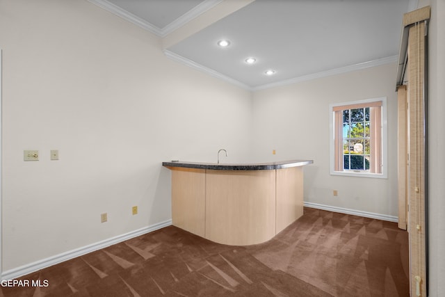 bar featuring light brown cabinetry, dark colored carpet, and ornamental molding