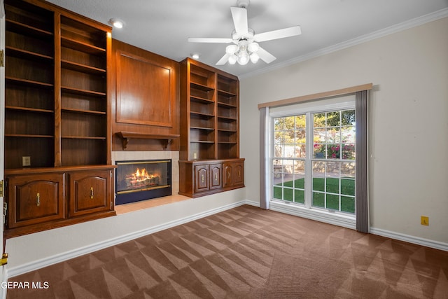 unfurnished living room with carpet flooring, ceiling fan, and crown molding