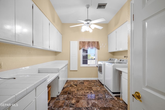 clothes washing area with cabinets, ceiling fan, and independent washer and dryer