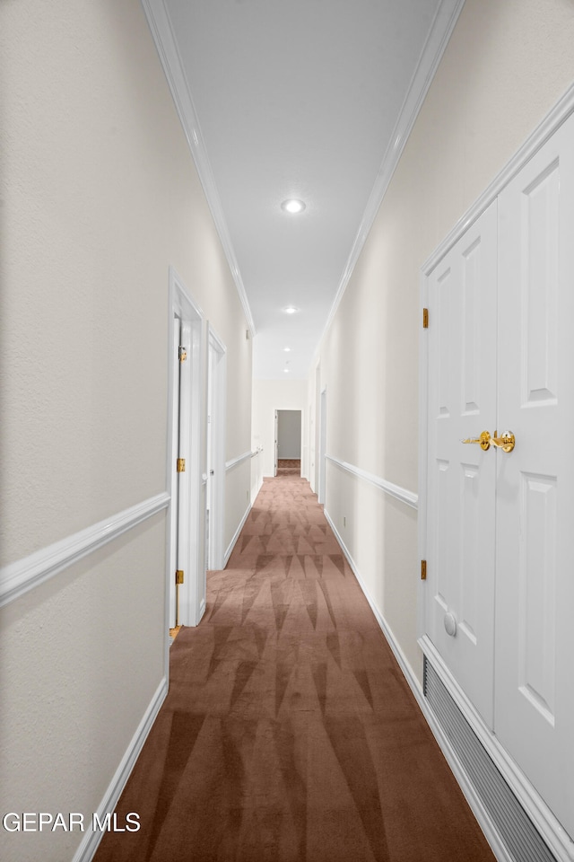 hallway with carpet and ornamental molding