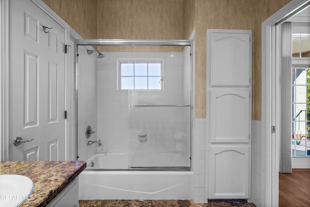 bathroom featuring shower / bath combination with glass door, vanity, and wood-type flooring