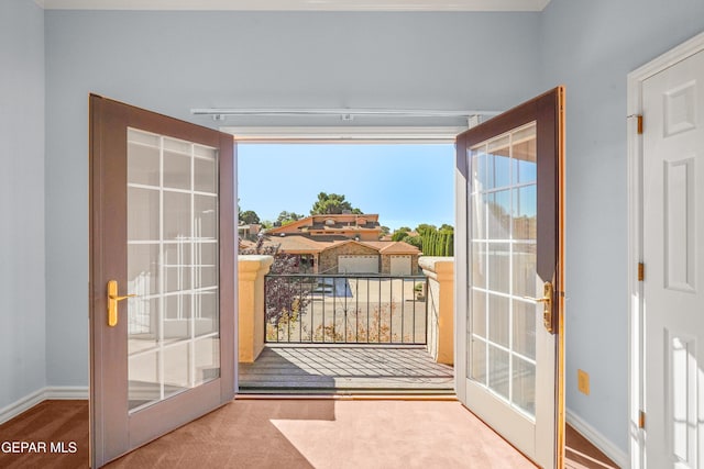 doorway to outside featuring carpet flooring, french doors, and a wealth of natural light