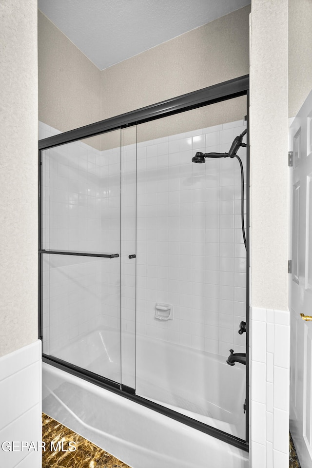 bathroom featuring bath / shower combo with glass door and hardwood / wood-style flooring