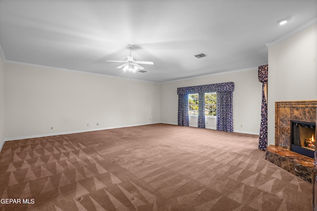 unfurnished living room with a high end fireplace, carpet floors, and crown molding