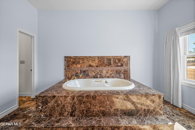 bathroom with tiled bath