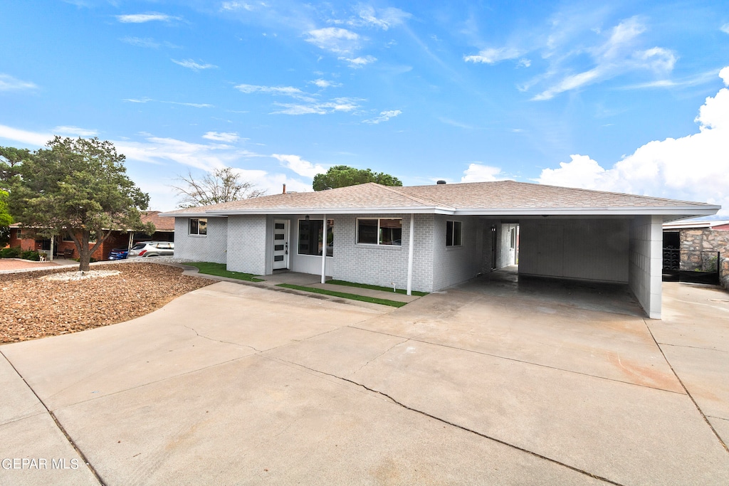 ranch-style home featuring a carport