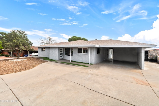 ranch-style home featuring a carport