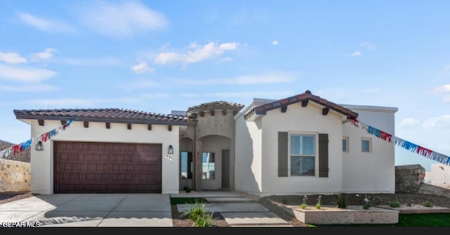 mediterranean / spanish-style home with a garage