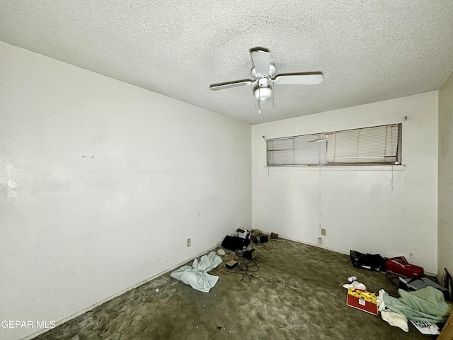 spare room featuring ceiling fan and a textured ceiling