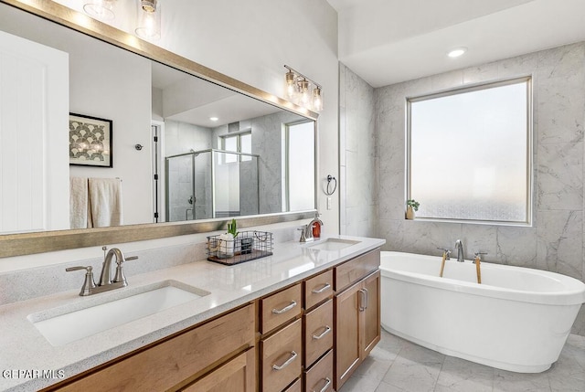 bathroom featuring vanity and shower with separate bathtub