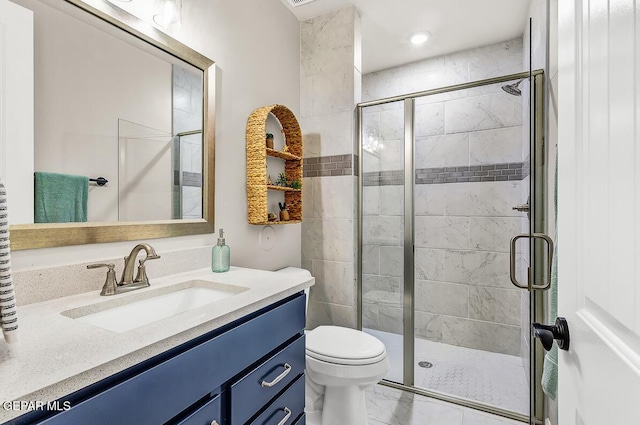 bathroom featuring an enclosed shower, vanity, and toilet