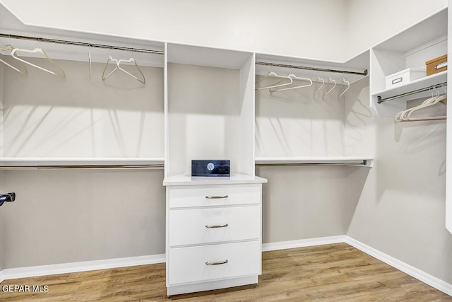 spacious closet with light hardwood / wood-style flooring