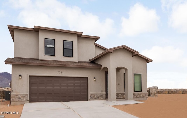 view of front of house featuring central air condition unit and a garage