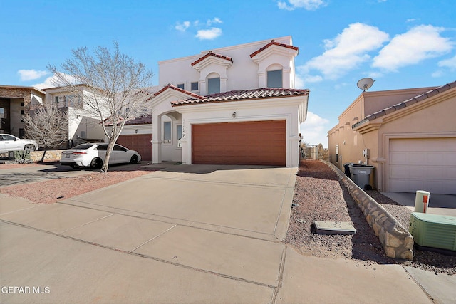 mediterranean / spanish-style home with a garage