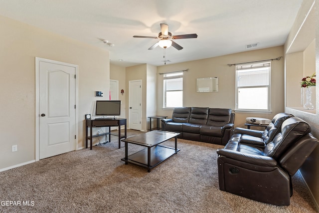 carpeted living room with ceiling fan