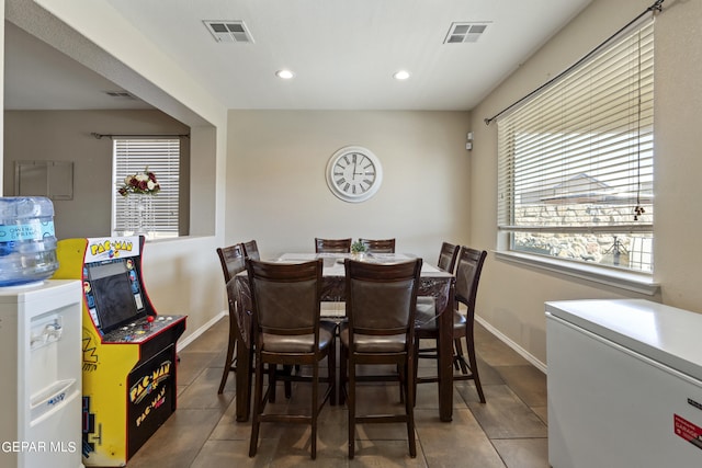 dining area with dark tile patterned floors