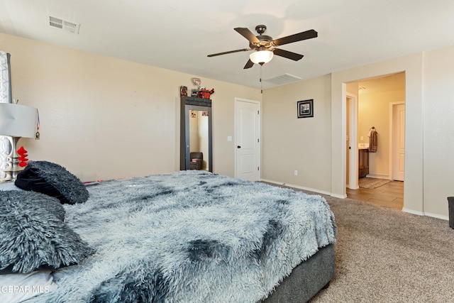 carpeted bedroom with ceiling fan and ensuite bathroom