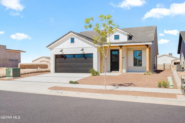 modern farmhouse with concrete driveway, central air condition unit, board and batten siding, fence, and a garage