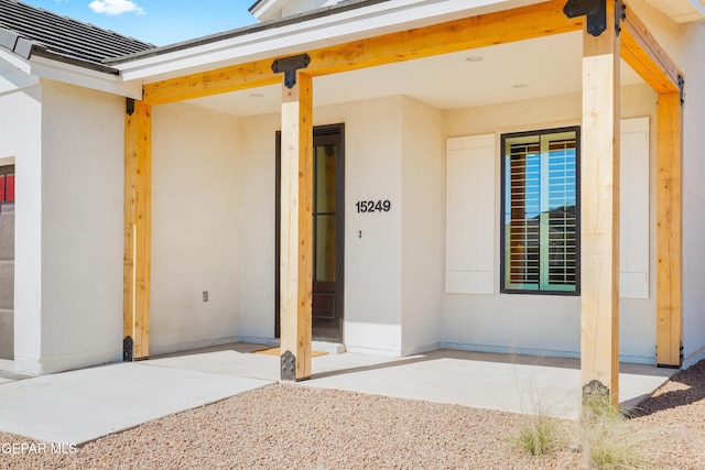 entrance to property featuring stucco siding