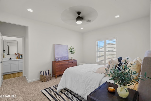 bedroom featuring recessed lighting, visible vents, connected bathroom, baseboards, and light colored carpet