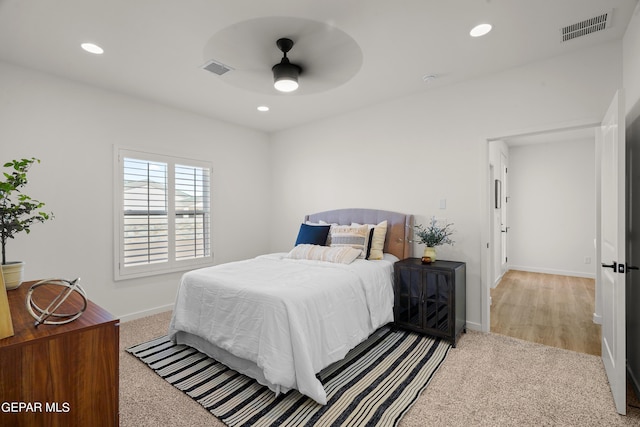 carpeted bedroom with baseboards, visible vents, and recessed lighting