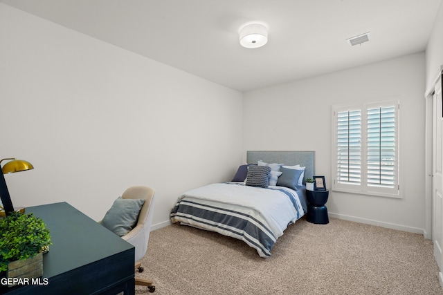 carpeted bedroom featuring visible vents and baseboards